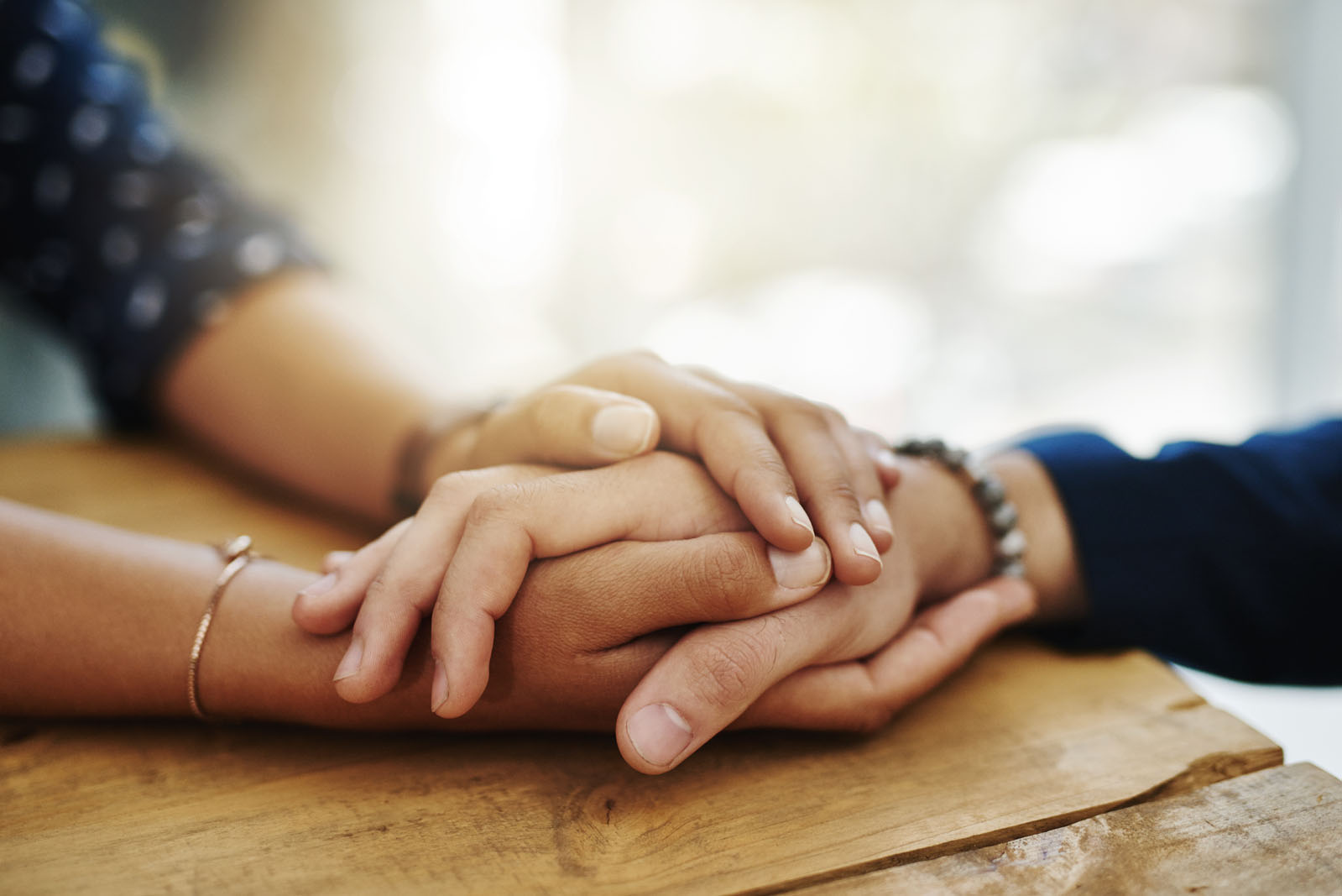 Holding hands, support and closeup with trust, solidarity and community